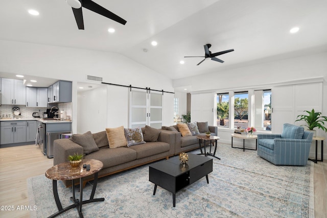 living area with light wood-type flooring, recessed lighting, ceiling fan, and lofted ceiling