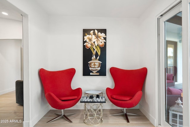 living area with recessed lighting, baseboards, and wood finished floors