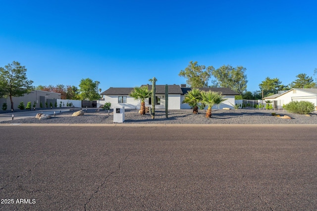single story home featuring fence and stucco siding