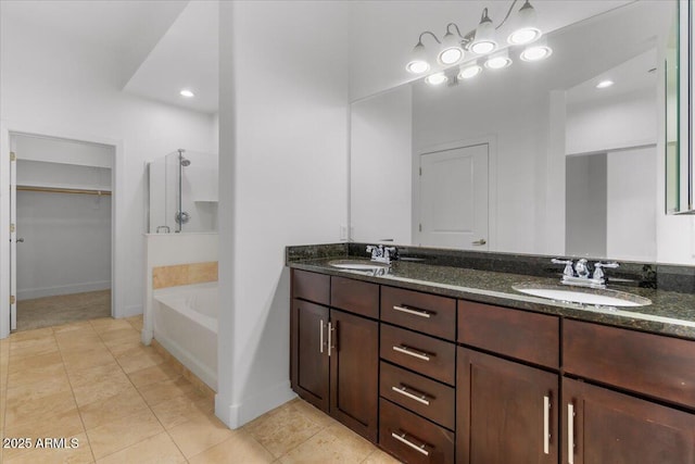 945 E Playa Del Norte Dr Unit 1016, Tempe, AZ 85288 - bathroom with double vanity, a walk in shower, a bath, a walk in closet, and tile patterned floors