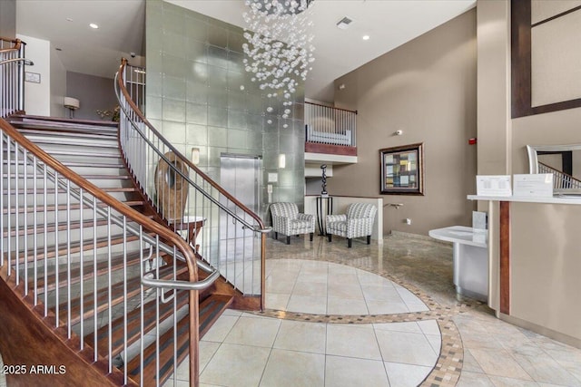 945 E Playa Del Norte Dr Unit 1016, Tempe, AZ 85288 - staircase featuring a towering ceiling, recessed lighting, and inlaid floor details