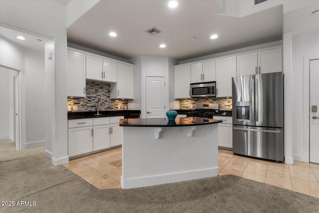 945 E Playa Del Norte Dr Unit 1016, Tempe, AZ 85288 - kitchen with appliances with stainless steel finishes, recessed lighting, dark countertops, white cabinets, and tasteful backsplash
