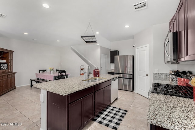 kitchen with visible vents, a center island with sink, recessed lighting, stainless steel appliances, and a sink