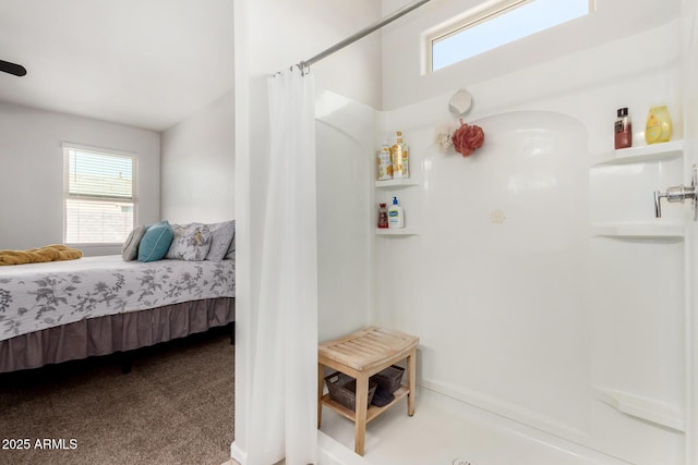 ensuite bathroom with connected bathroom, a shower with curtain, and a healthy amount of sunlight