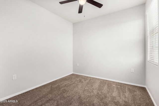 carpeted empty room featuring ceiling fan and baseboards