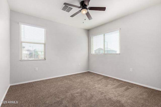 unfurnished room with visible vents, baseboards, carpet floors, and ceiling fan