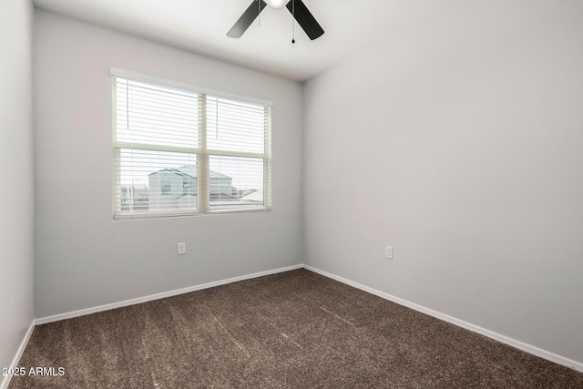 unfurnished room with dark colored carpet, baseboards, and ceiling fan