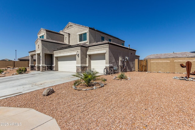 view of front facade with stucco siding, stone siding, an attached garage, and fence