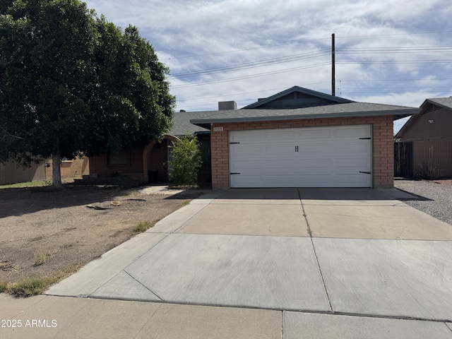 11221 N 91st Dr, Peoria, AZ 85345 - view of front of property with brick siding, concrete driveway, and a shingled roof
