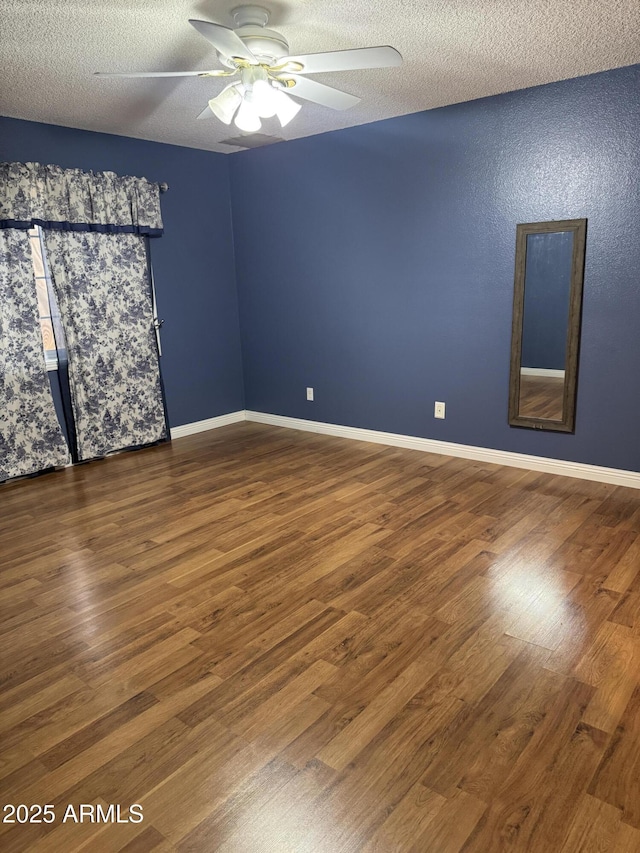 11221 N 91st Dr, Peoria, AZ 85345 - unfurnished room with dark wood-style floors, a ceiling fan, a textured ceiling, and baseboards