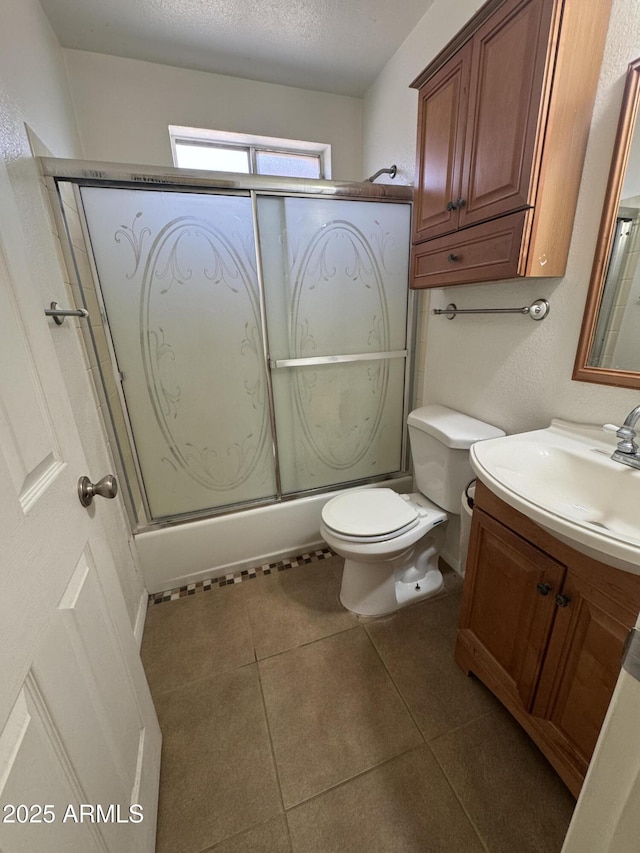 11221 N 91st Dr, Peoria, AZ 85345 - bathroom featuring vanity, toilet, a textured ceiling, tile patterned floors, and shower / bath combination with glass door