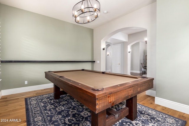 recreation room featuring pool table, light hardwood / wood-style floors, and an inviting chandelier