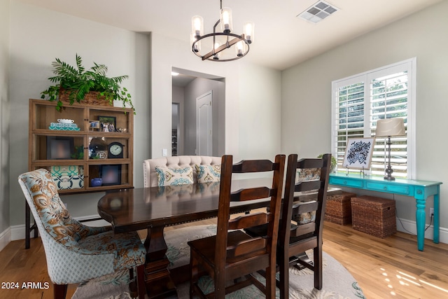 dining area featuring hardwood / wood-style floors and a chandelier