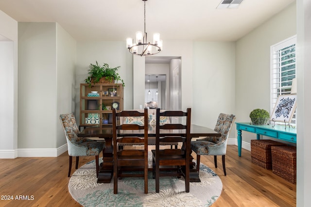 dining room featuring wood-type flooring and a notable chandelier