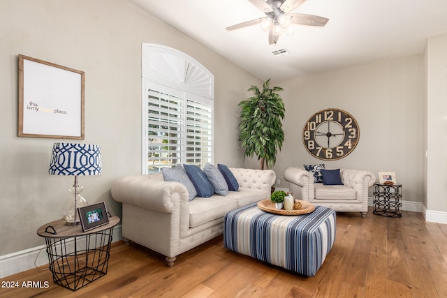 living room with hardwood / wood-style floors and ceiling fan