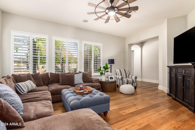 living room with ceiling fan, light hardwood / wood-style flooring, and a healthy amount of sunlight