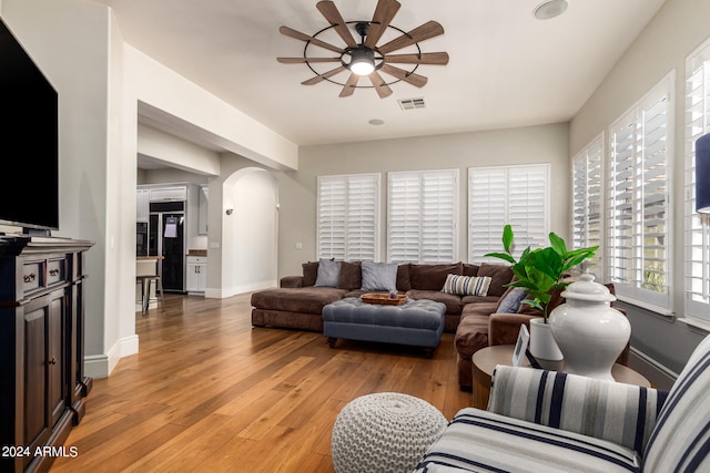 living room with ceiling fan and light hardwood / wood-style flooring