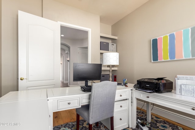 home office with hardwood / wood-style floors and built in desk