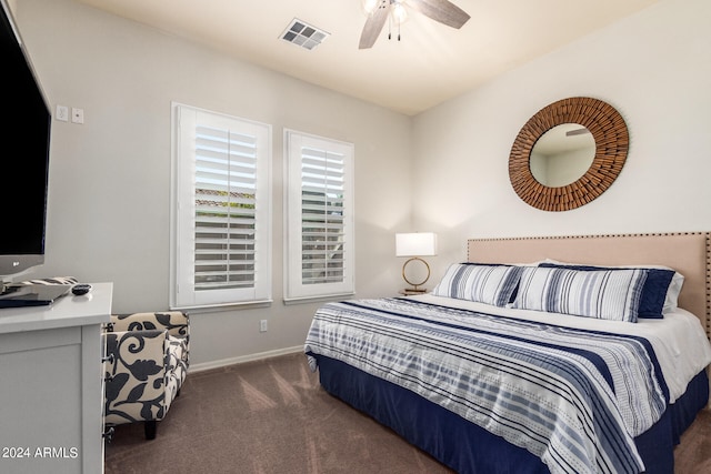 bedroom with dark colored carpet and ceiling fan