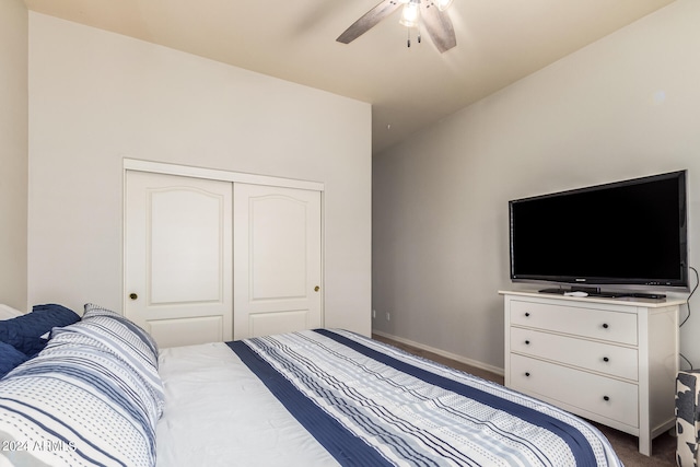 carpeted bedroom featuring ceiling fan and a closet