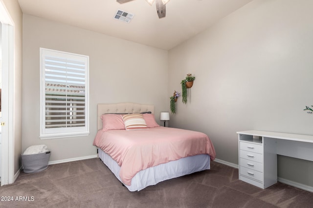 bedroom with ceiling fan and dark colored carpet