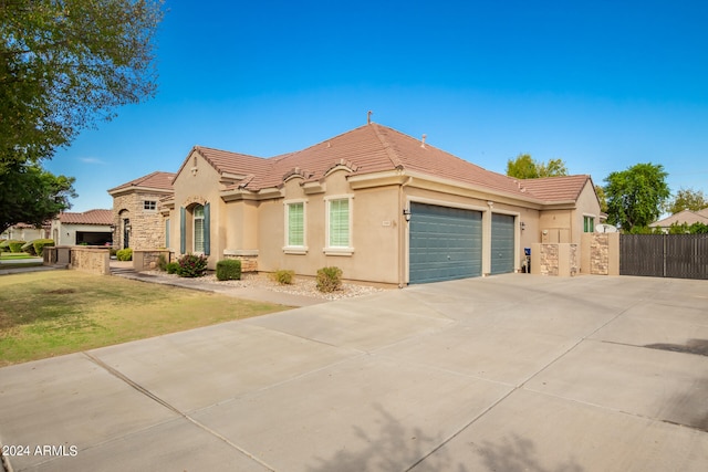 view of front of home featuring a garage and a front lawn