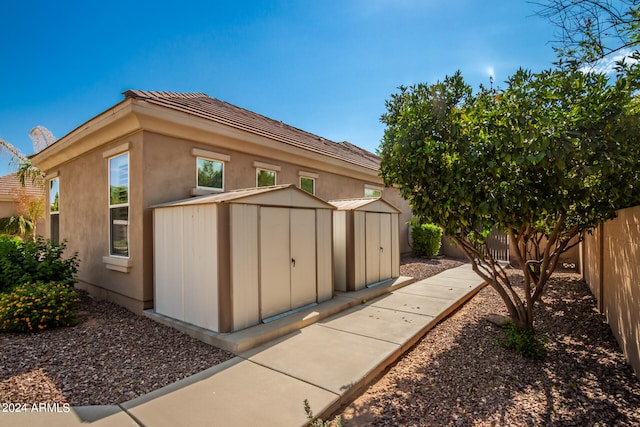 view of property exterior with a storage shed