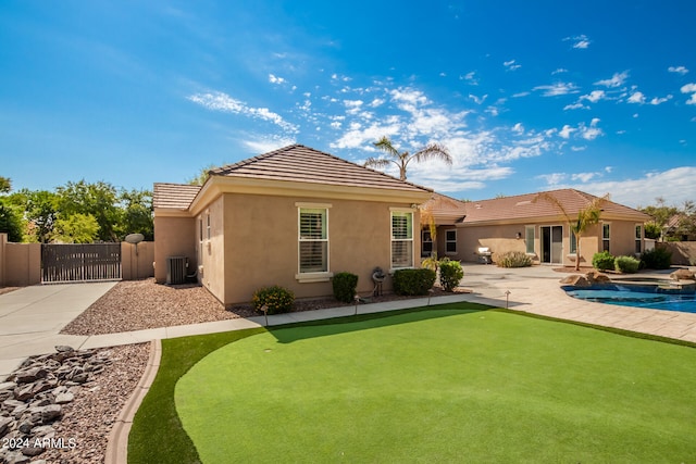 rear view of property featuring cooling unit and a patio area