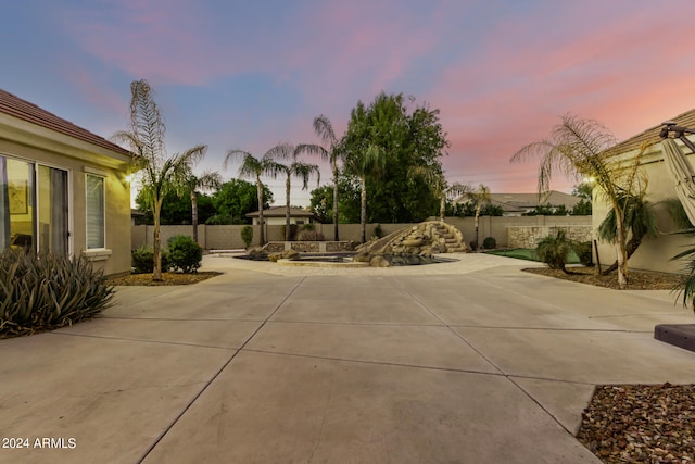 view of patio terrace at dusk