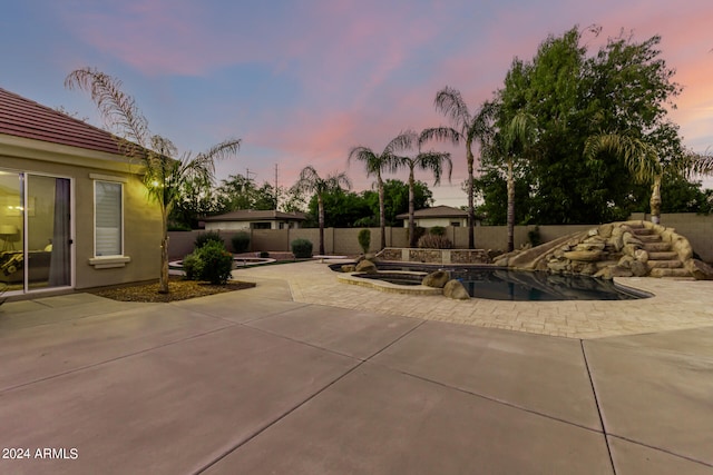 view of patio terrace at dusk