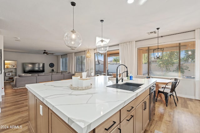 2811 E Riviera Pl, Chandler, AZ 85249 - kitchen with a sink, light wood-style flooring, light stone counters, and pendant lighting