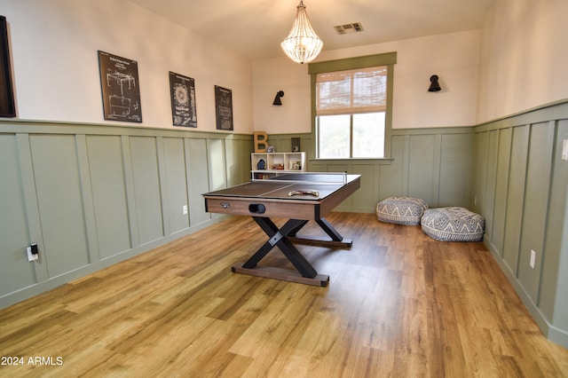 office space with a notable chandelier and light wood-type flooring