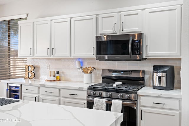2811 E Riviera Pl, Chandler, AZ 85249 - kitchen with appliances with stainless steel finishes, white cabinets, and decorative backsplash