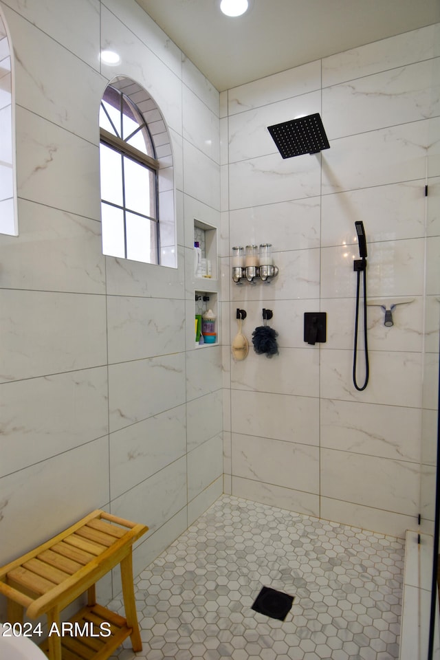 bathroom with a tile shower