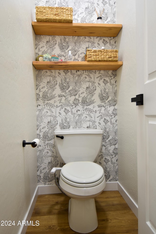 bathroom featuring hardwood / wood-style flooring and toilet