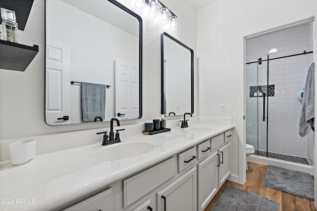 2811 E Riviera Pl, Chandler, AZ 85249 - bathroom featuring toilet, a stall shower, double vanity, and wood finished floors