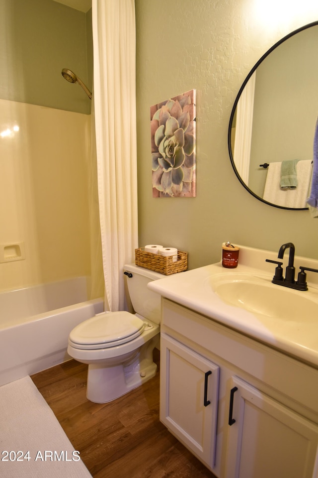 full bathroom featuring vanity, toilet, wood-type flooring, and shower / tub combo