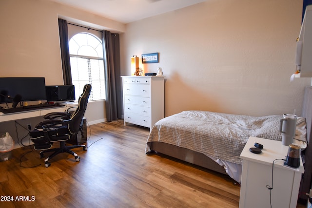 bedroom with wood-type flooring