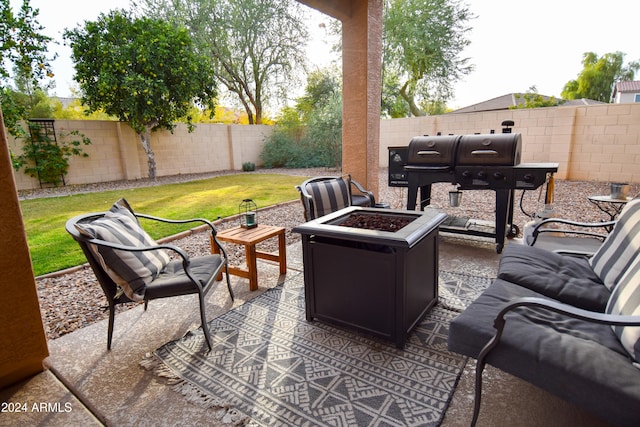 view of patio featuring grilling area and an outdoor living space with a fire pit