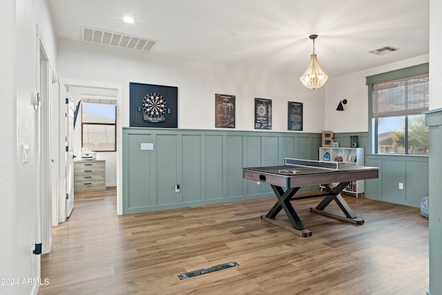 2811 E Riviera Pl, Chandler, AZ 85249 - game room with a chandelier, light wood-type flooring, a wainscoted wall, and a decorative wall