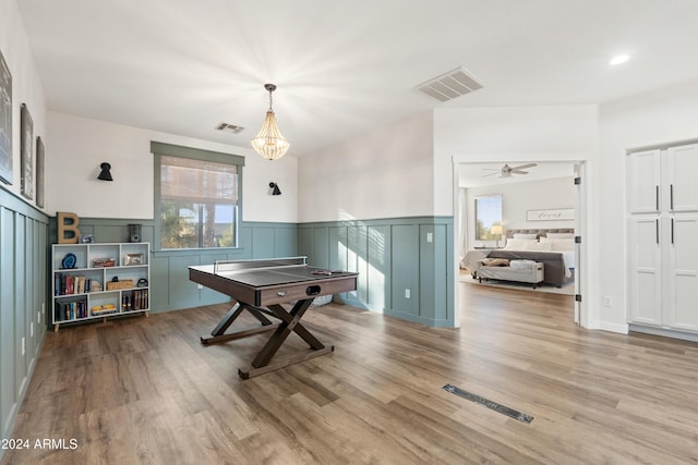 2811 E Riviera Pl, Chandler, AZ 85249 - rec room featuring plenty of natural light, wainscoting, wood finished floors, a decorative wall, and a chandelier