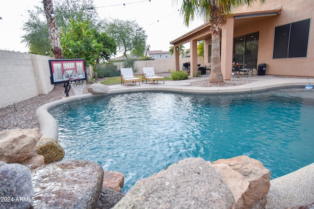 view of swimming pool with a patio area and pool water feature