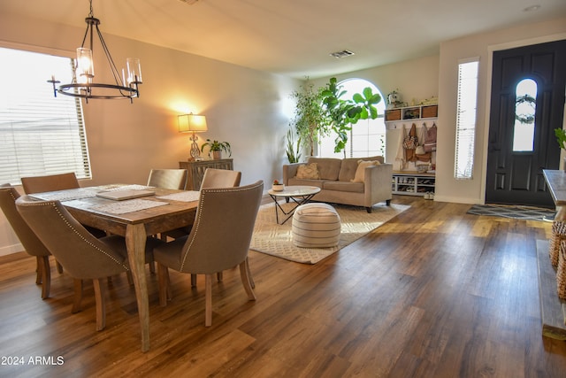 dining room featuring hardwood / wood-style flooring and a chandelier