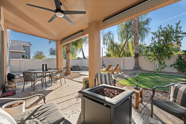 view of patio / terrace featuring ceiling fan and an outdoor fire pit