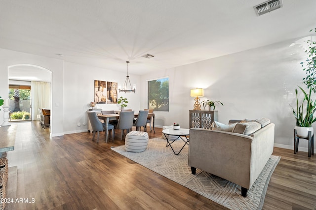 2811 E Riviera Pl, Chandler, AZ 85249 - living room featuring arched walkways, wood finished floors, a chandelier, and baseboards