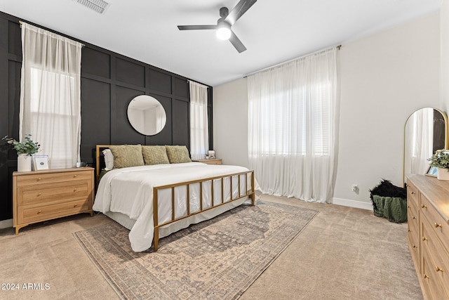 bedroom with ceiling fan and light colored carpet