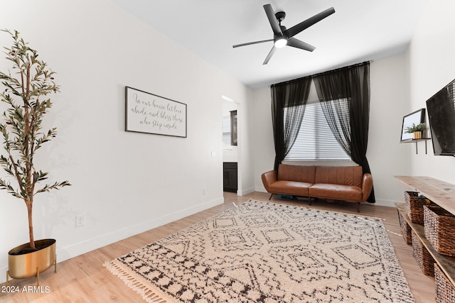 living area featuring ceiling fan and hardwood / wood-style floors