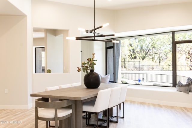 dining area with hardwood / wood-style flooring and a chandelier