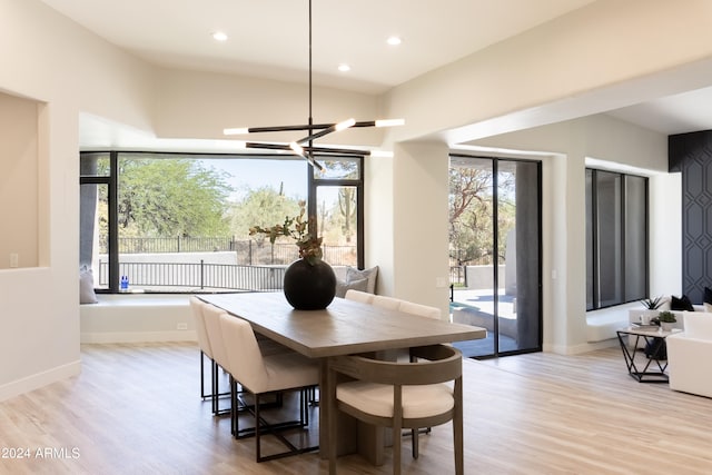 dining area with a chandelier, plenty of natural light, and light hardwood / wood-style floors