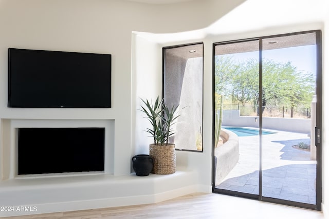 unfurnished living room featuring baseboards and wood finished floors